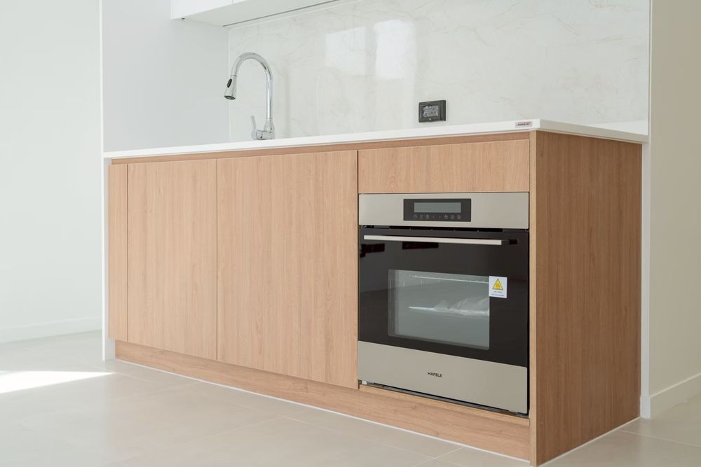Kitchen with Häfele oven and wood-finish cabinetry